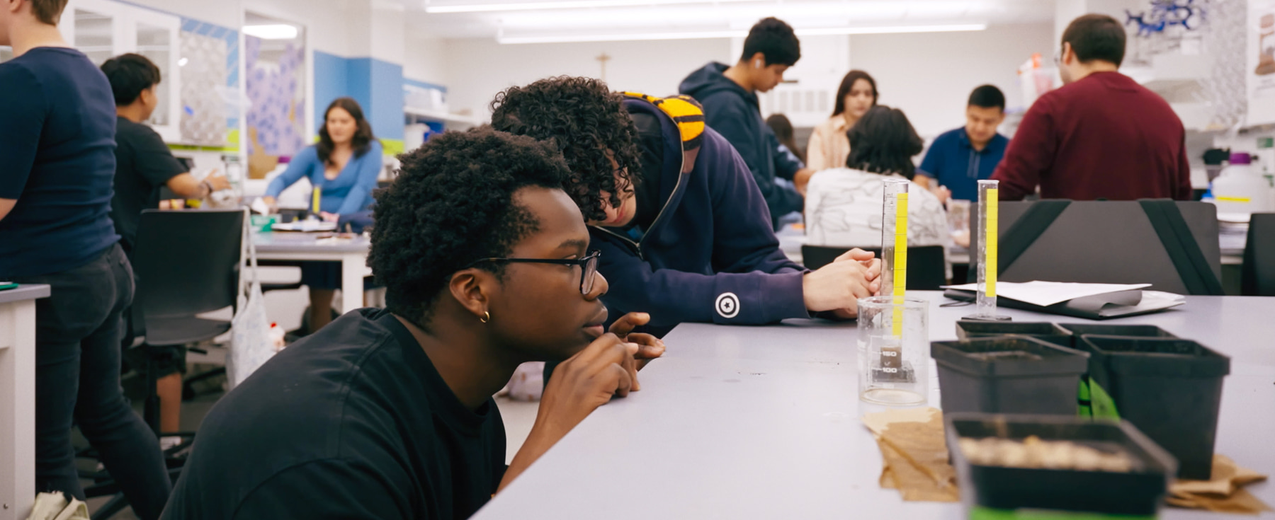 Arrupe College students engaged in hands-on laboratory work, analyzing materials